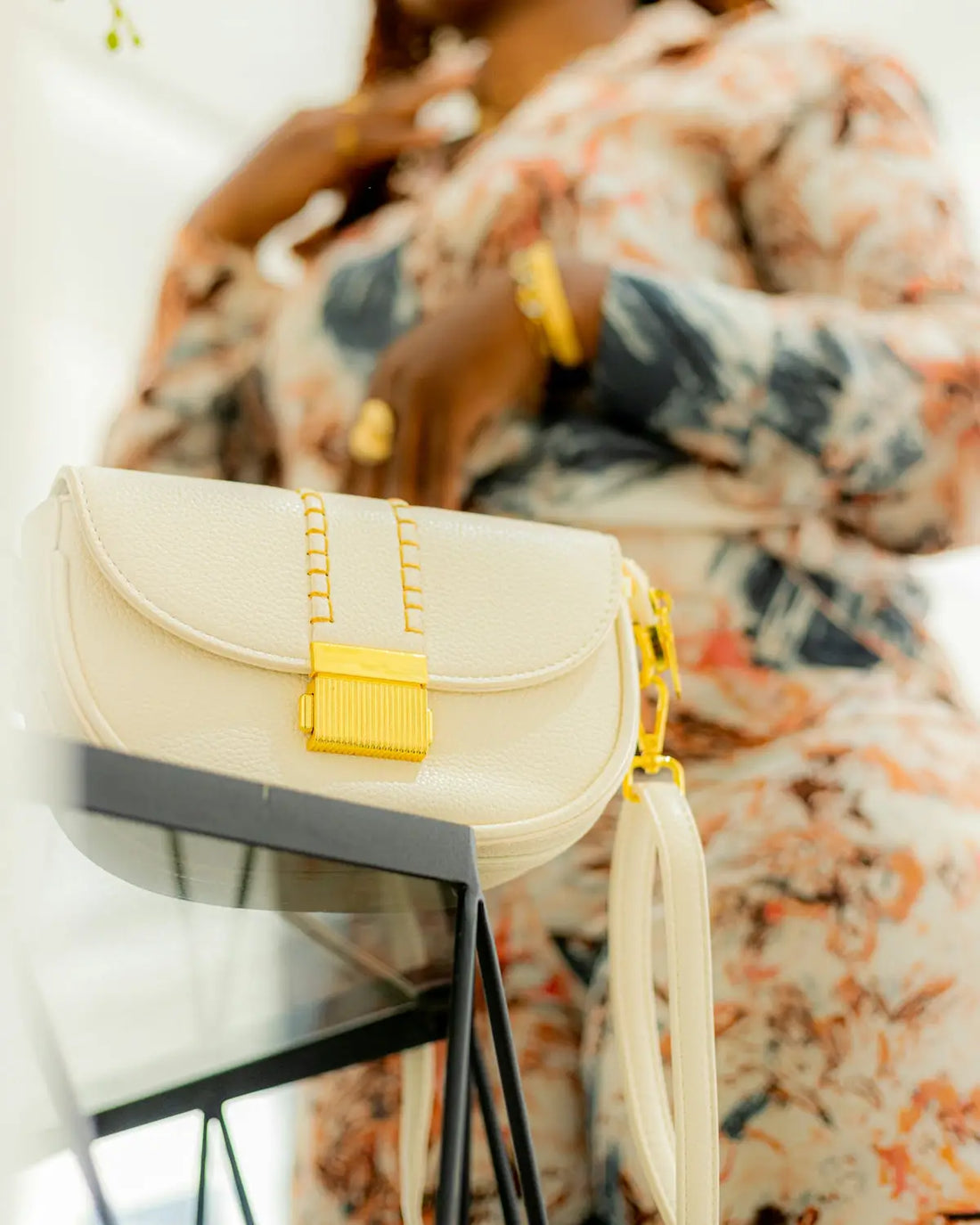 A stylish woman poses with her handbag.