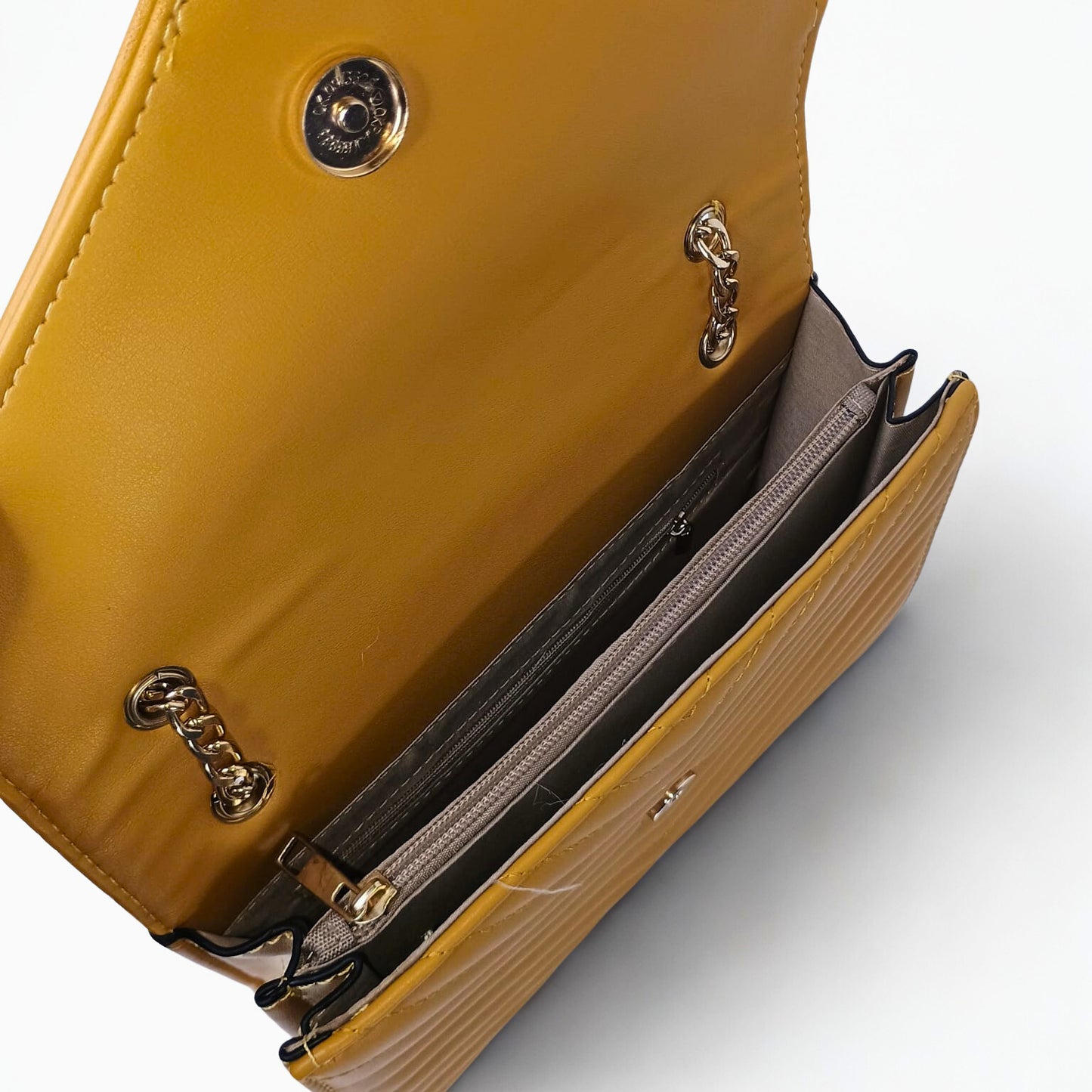 Yellow handbag with gold chain details on a white background