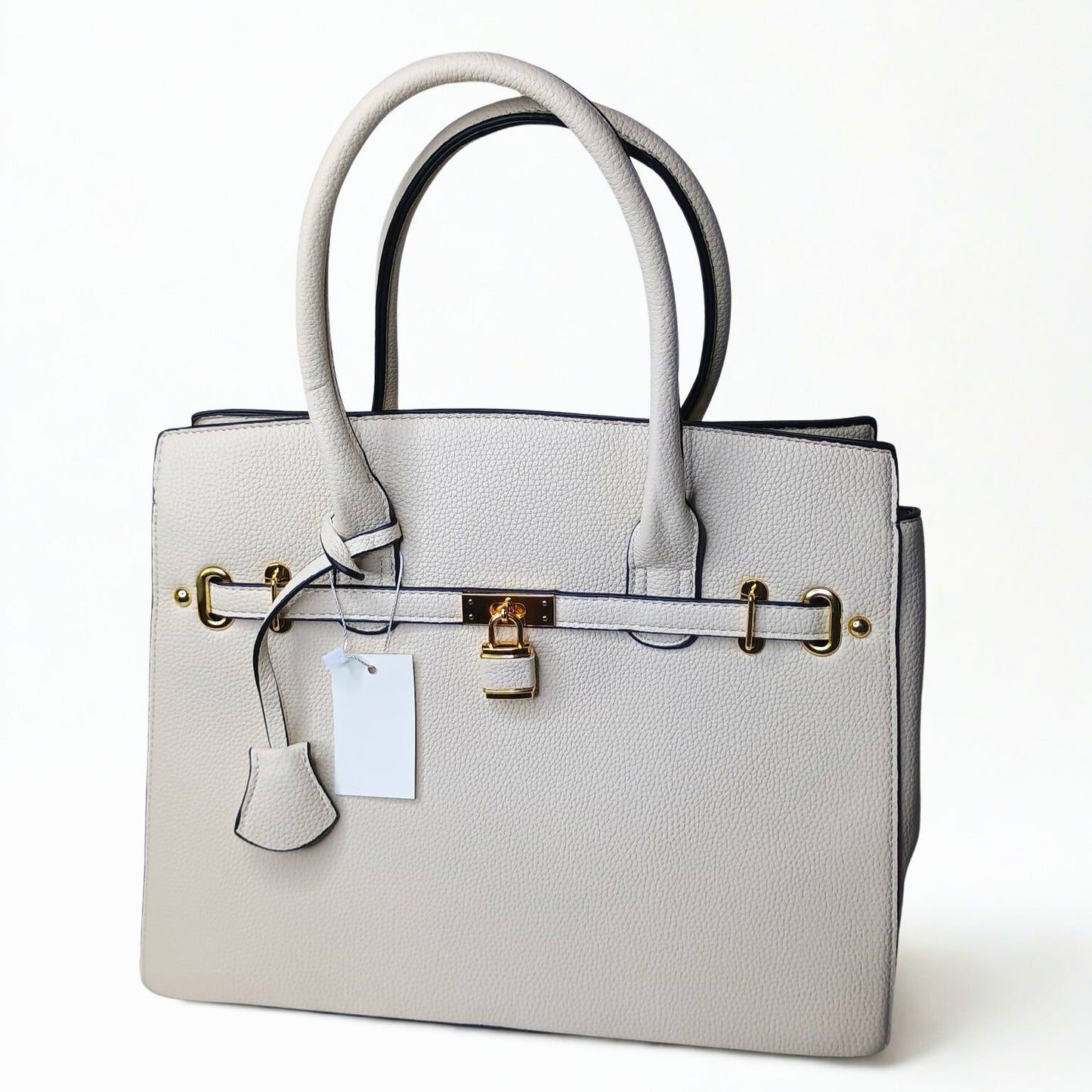 Gray handbag with gold hardware on a white background