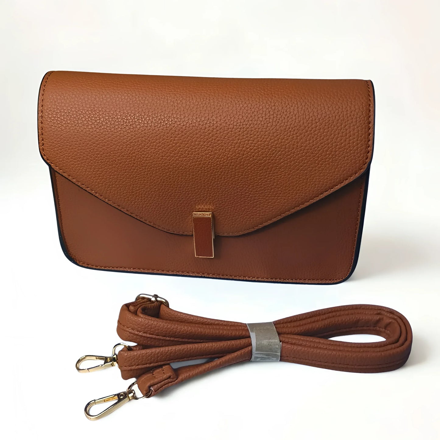 Brown leather handbag with matching strap on a white background
