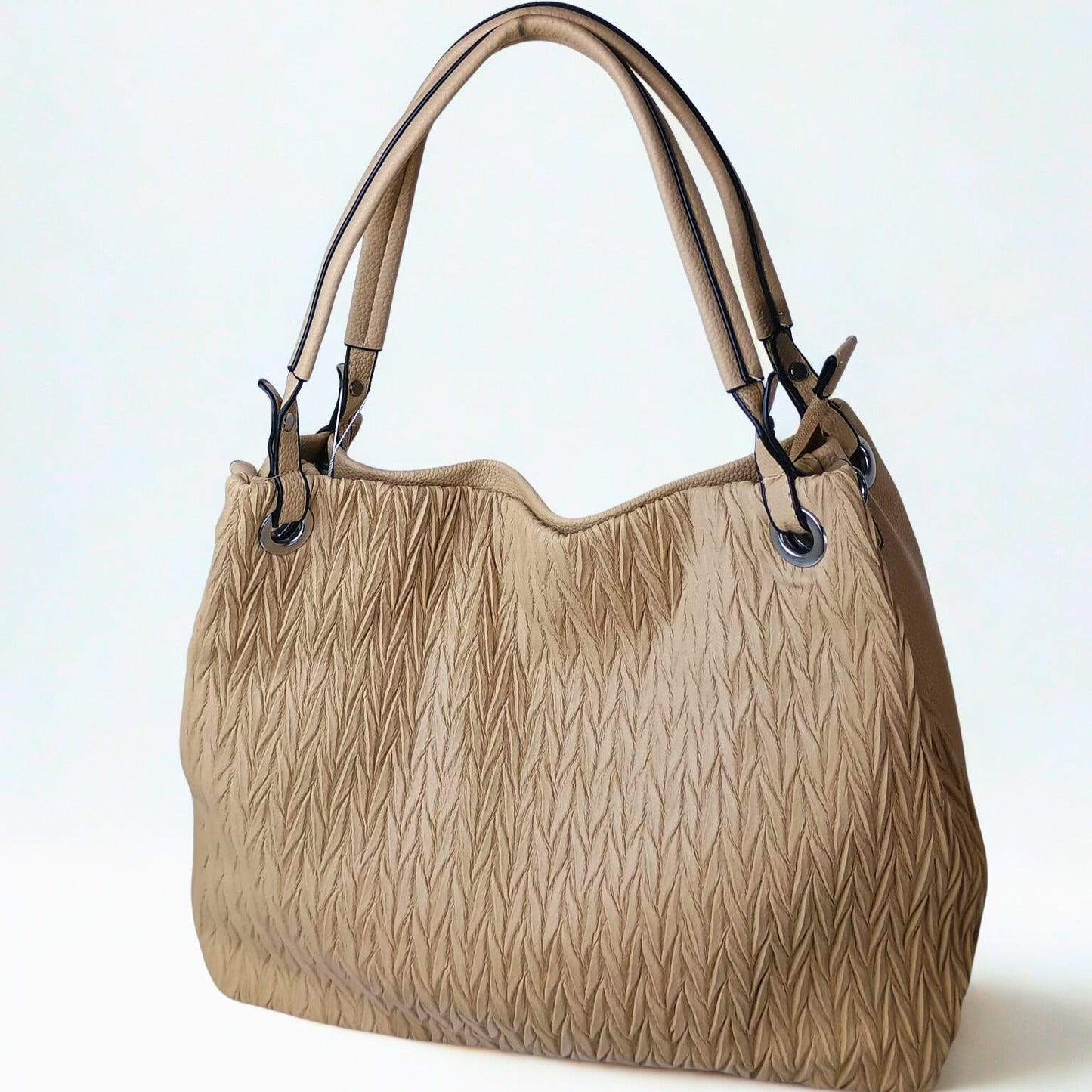 Beige handbag with textured pattern on a light background