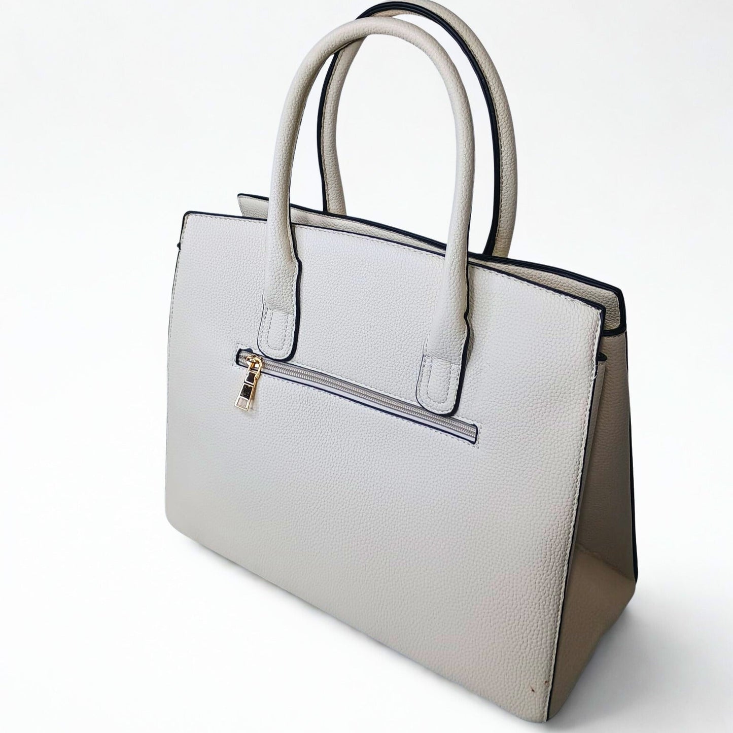 White handbag with beige accents on a white background