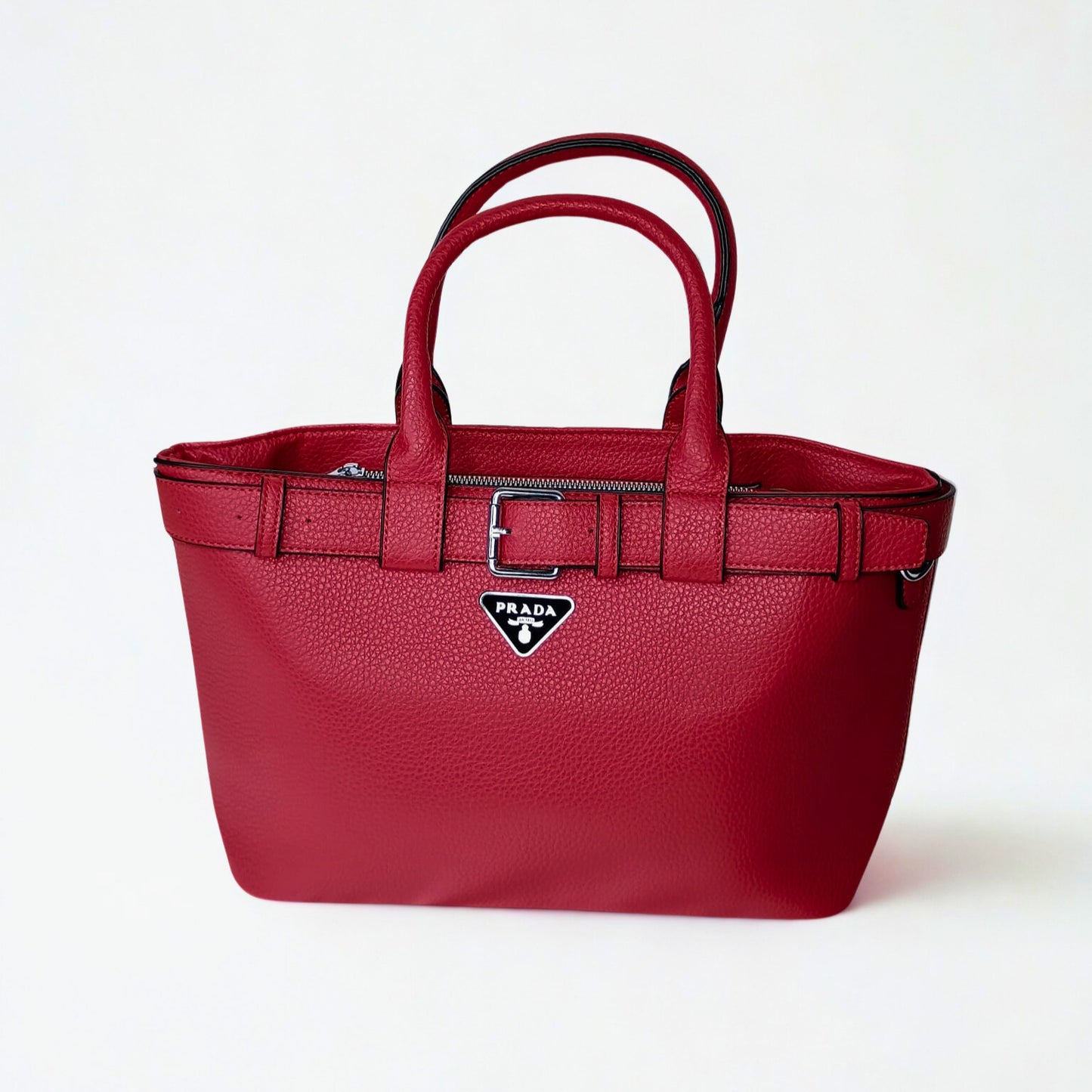 Red handbag with Prada logo on a white background