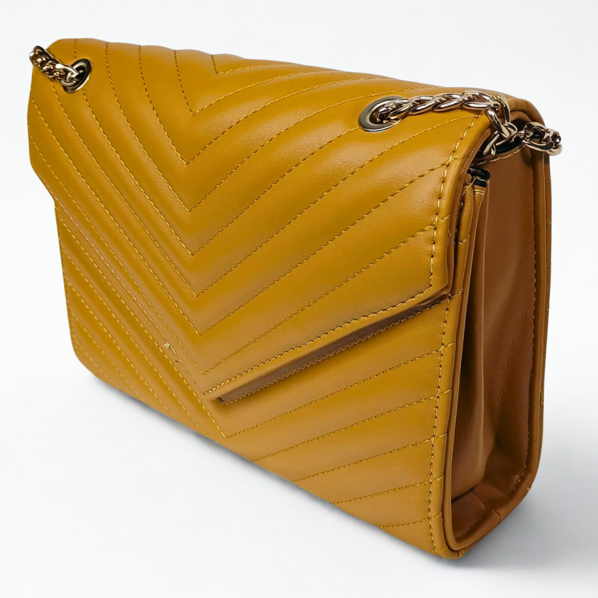 Yellow quilted handbag with a chain strap on a white background