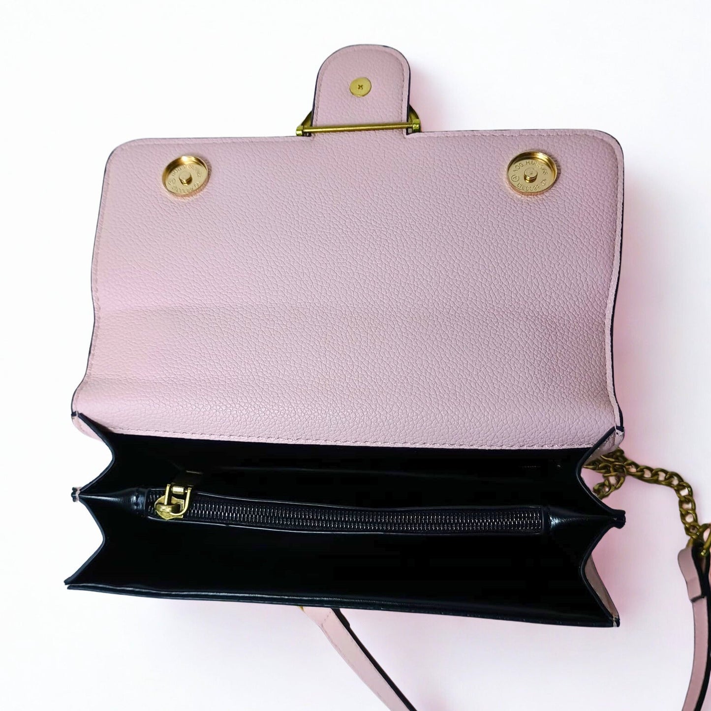 Pink handbag with gold accents on a white background