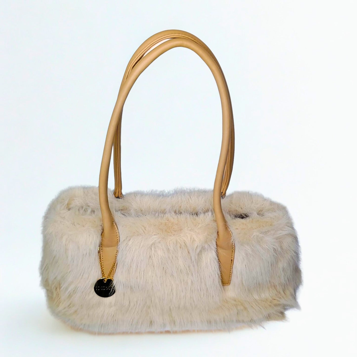 Furry handbag with beige handle on a white background