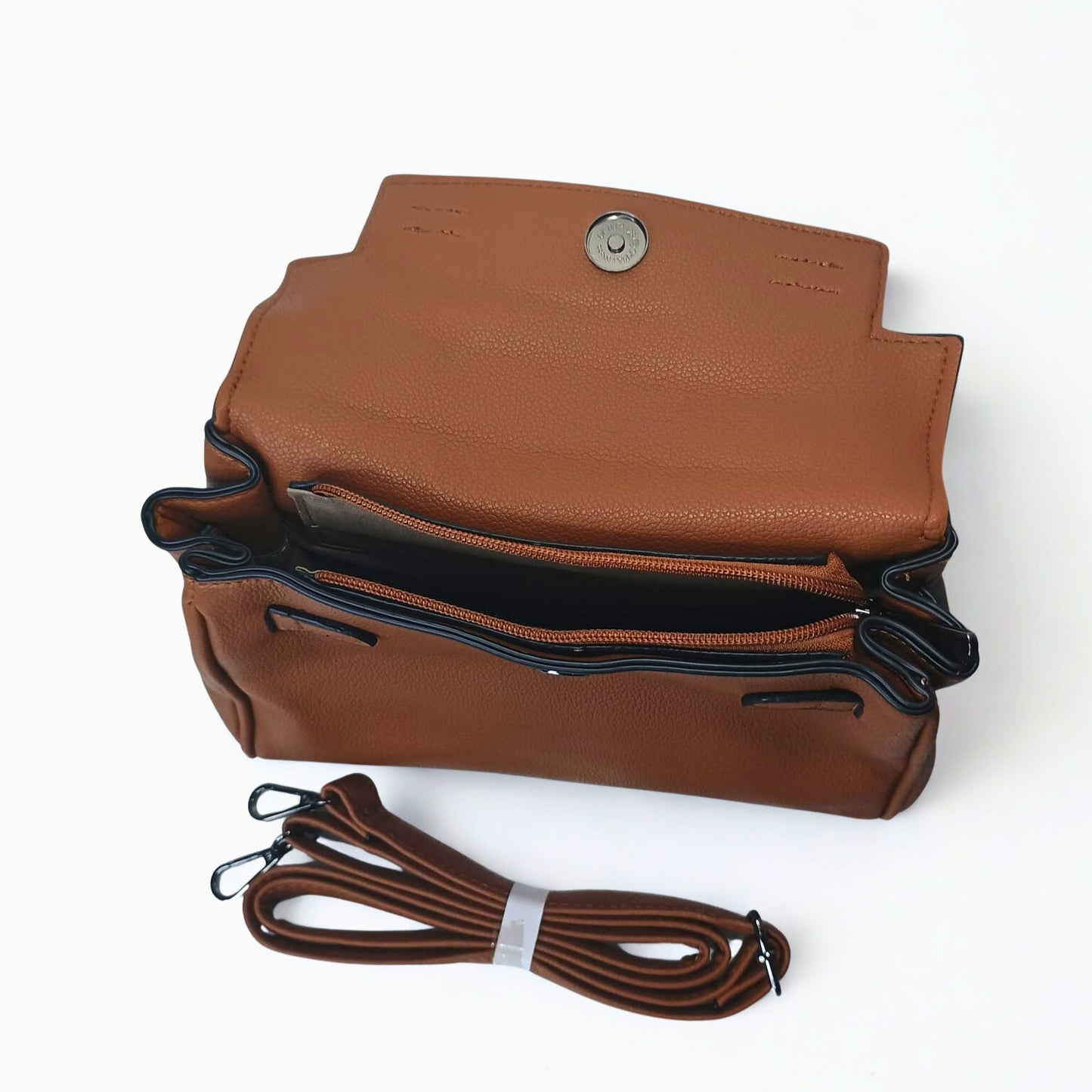 Brown leather handbag with a strap on a white background