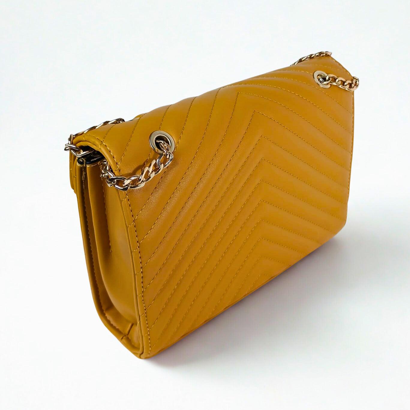 Yellow handbag with a gold chain strap on a white background