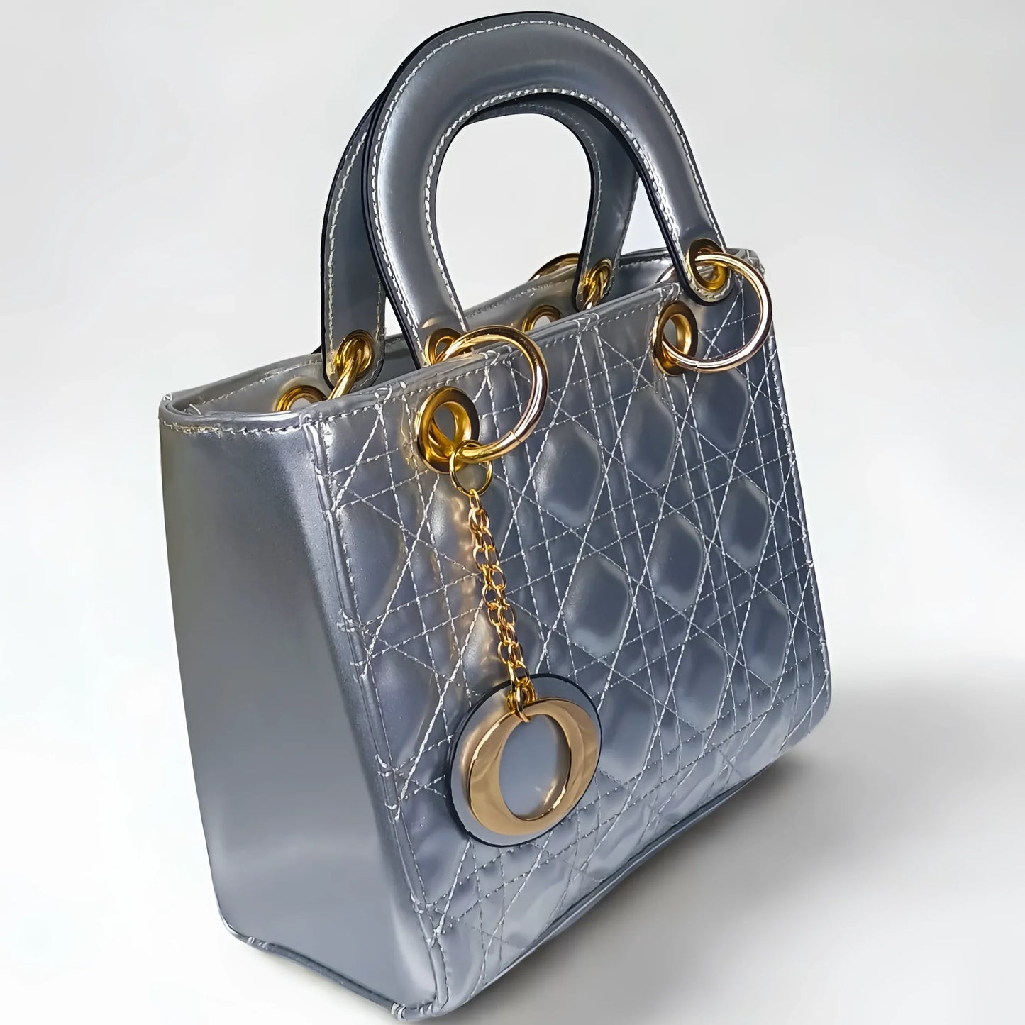 Silver handbag with gold accents on a white background