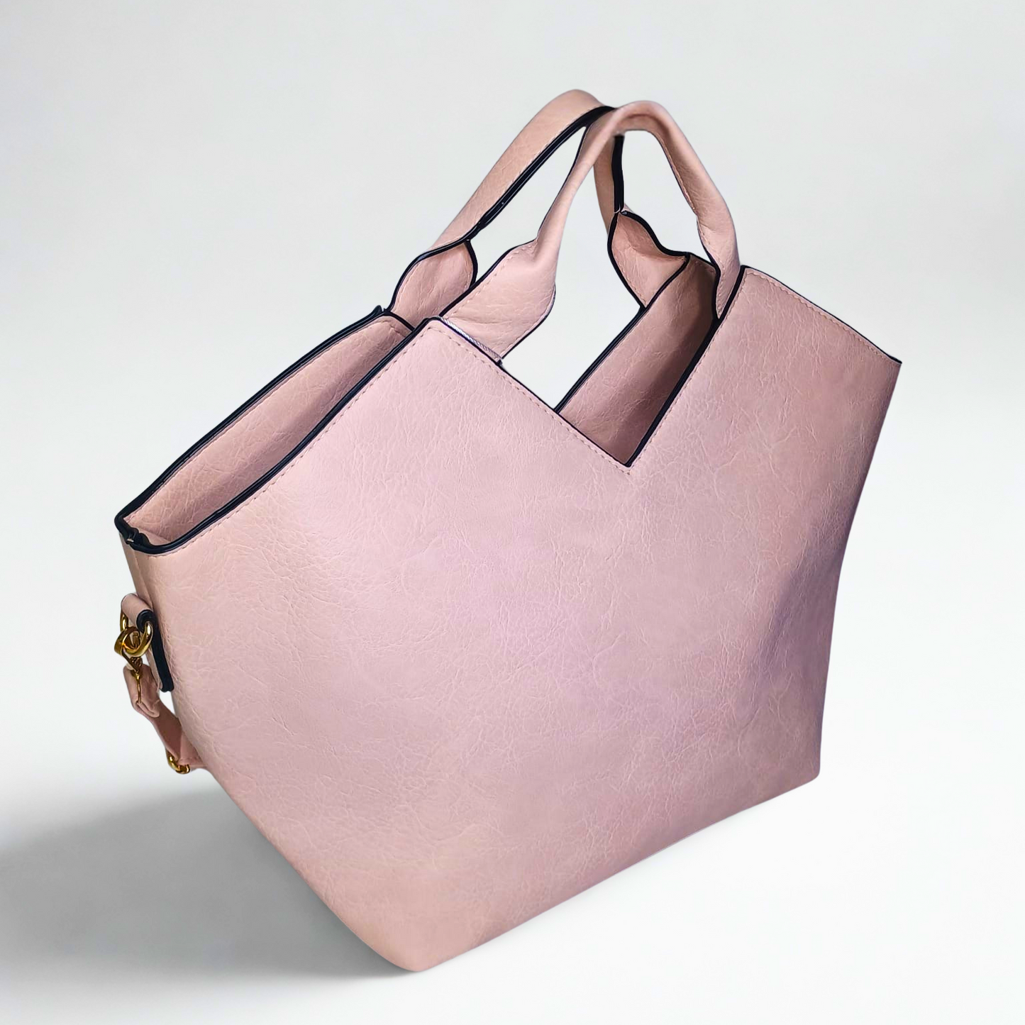 Pink tote bag with black accents on a light gray background