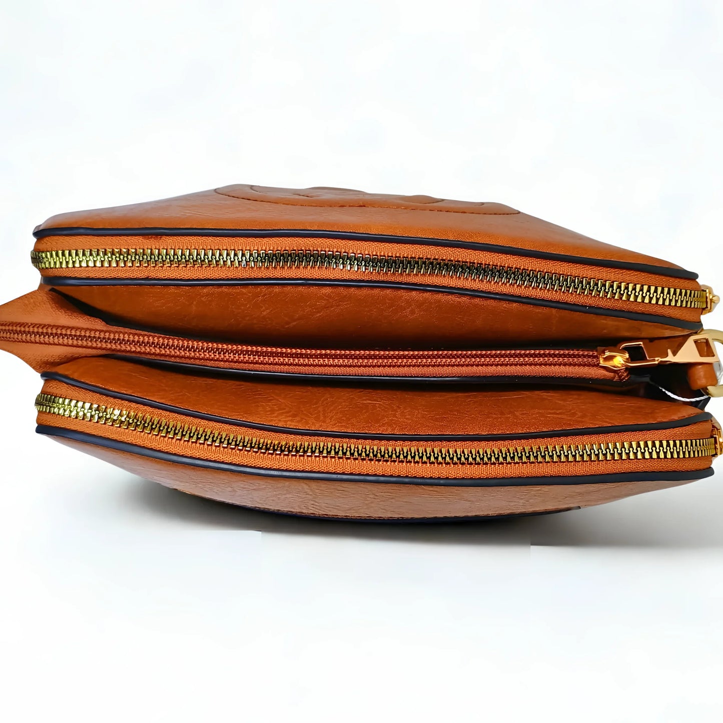 Brown leather bag with gold zippers on a white background