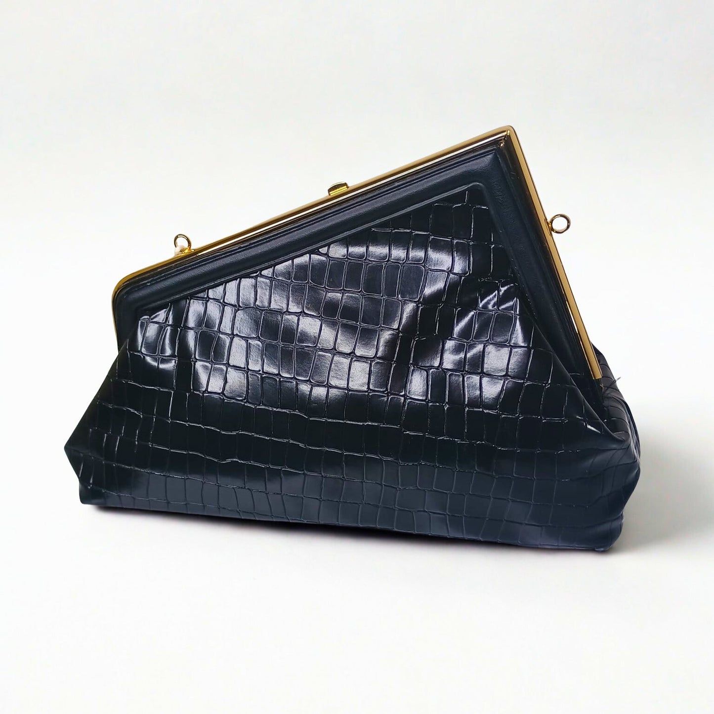 Black crocodile-patterned handbag with gold frame on a white background