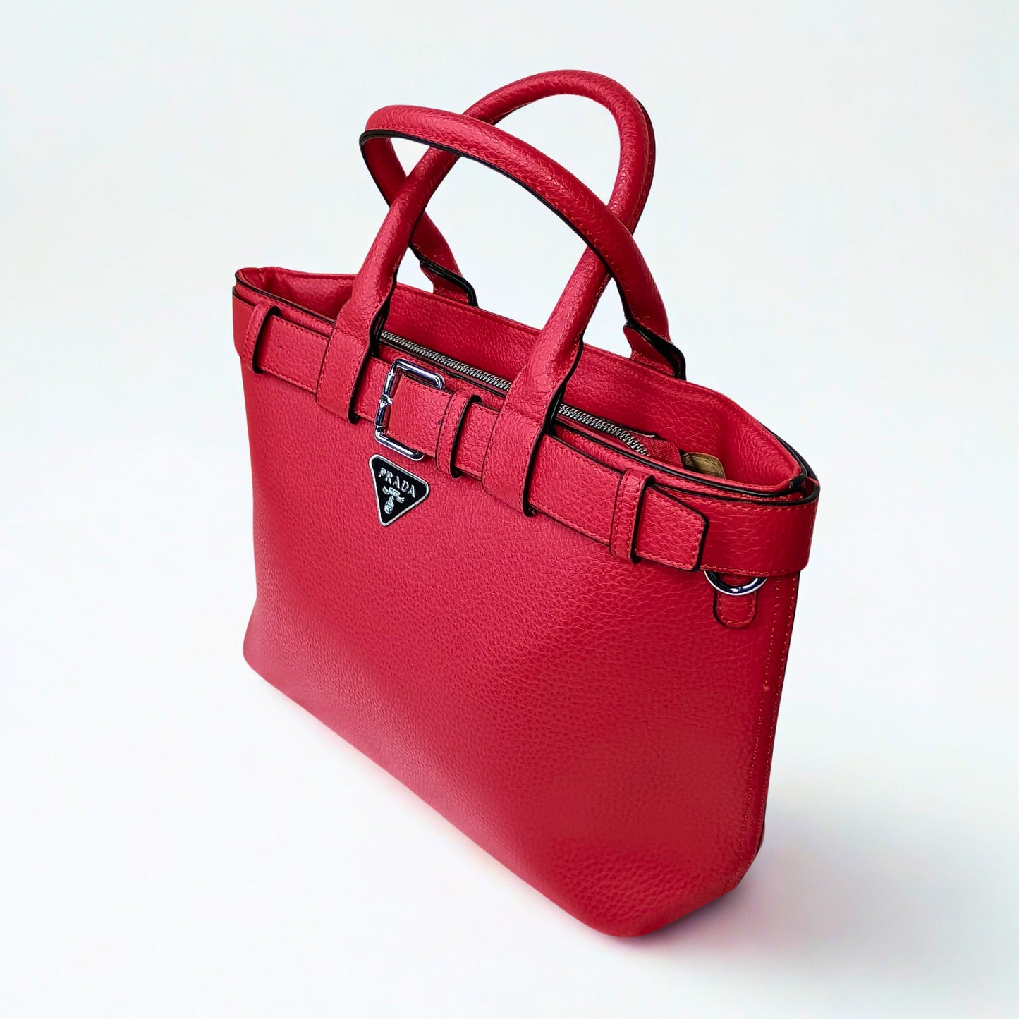 Red handbag with a visible brand logo on a white background