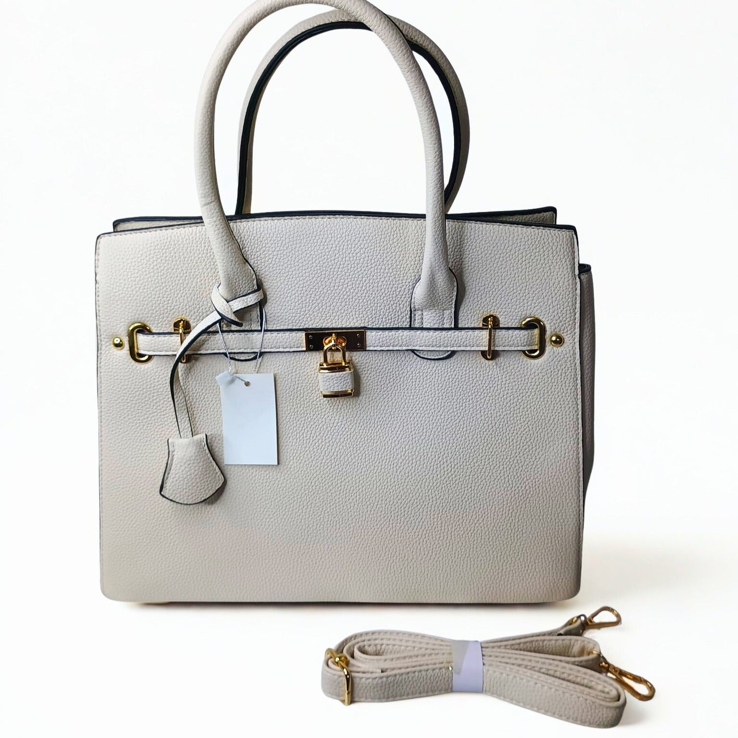 Light gray handbag with matching strap on a white background