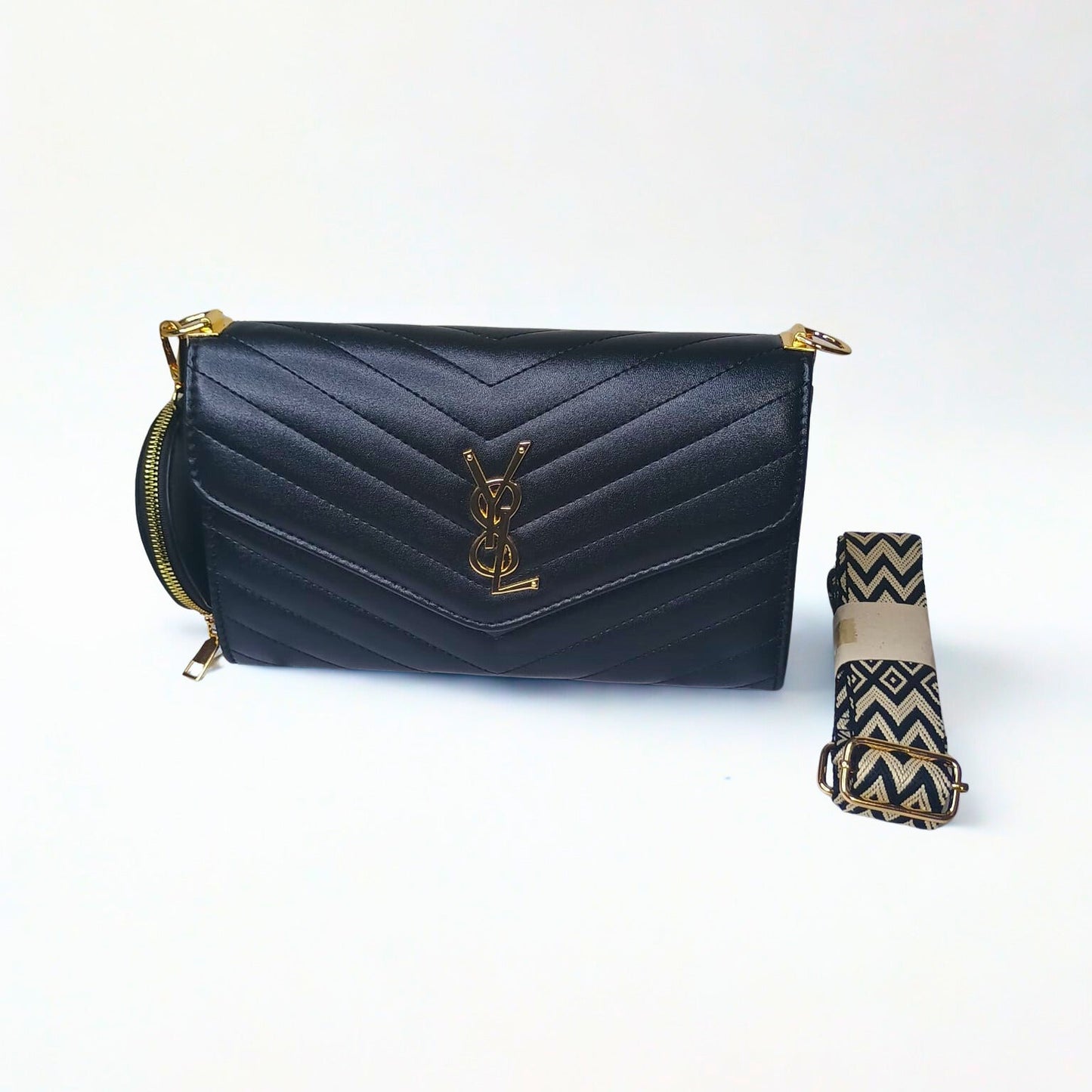 Black quilted handbag with gold accents and a matching umbrella on a white background