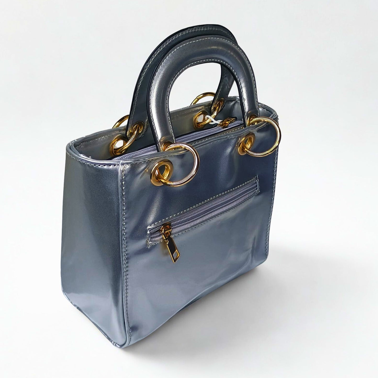 Blue handbag with gold accents on a white background