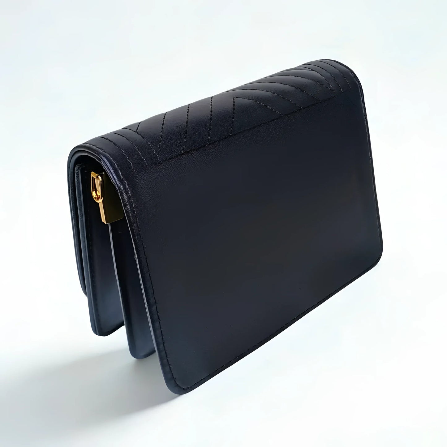 Black quilted handbag on a white background