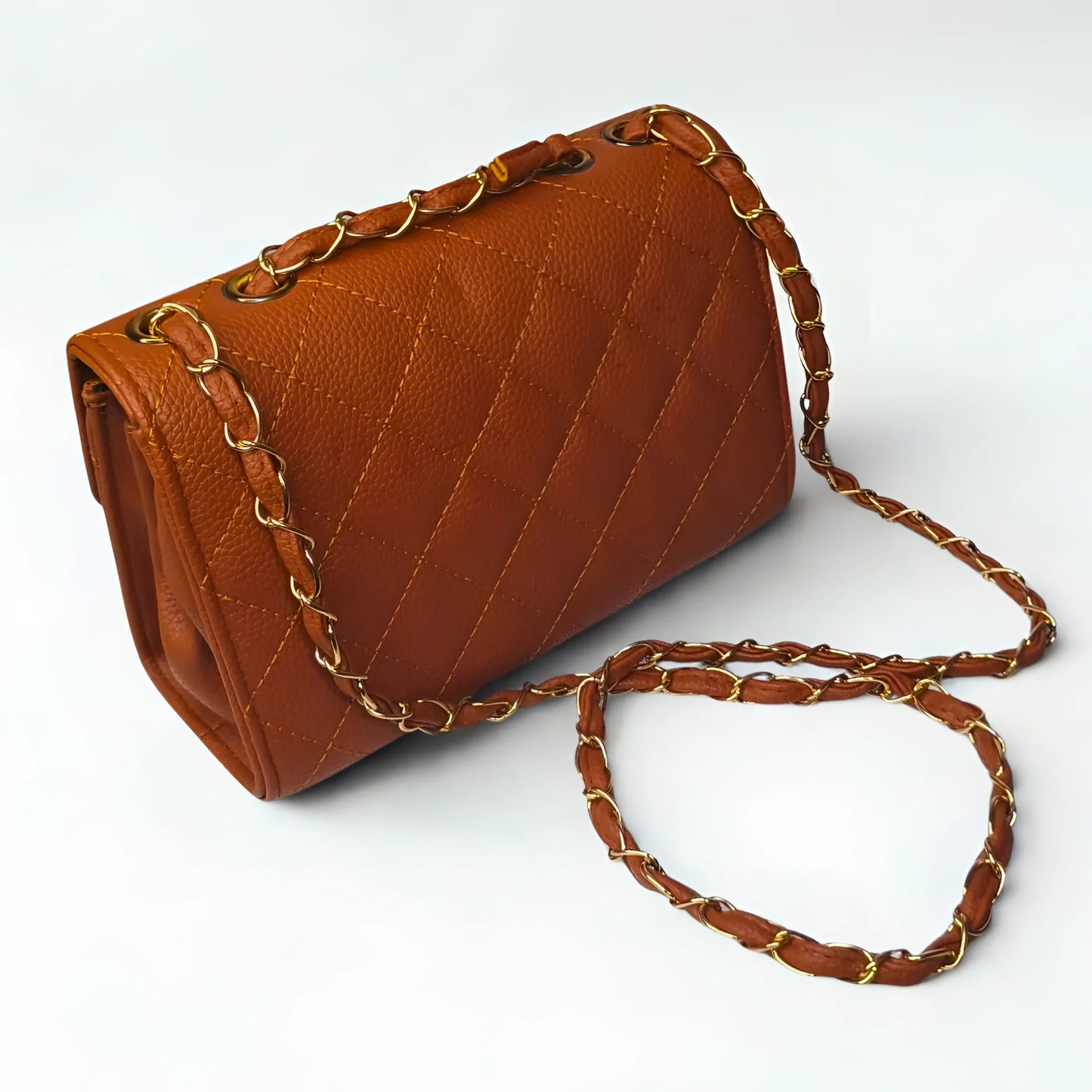 Brown handbag with gold chain strap on a white background