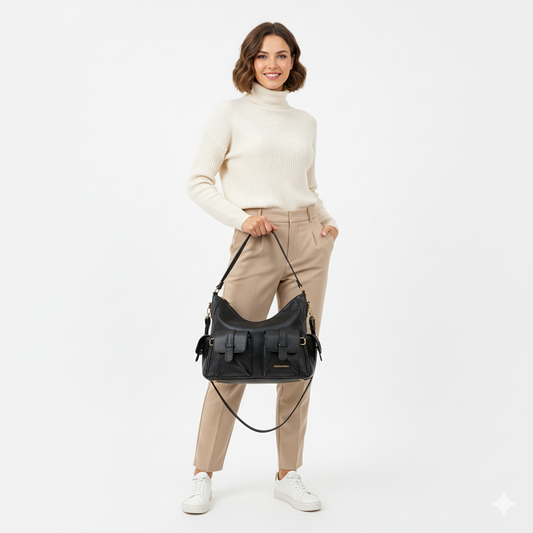 Woman holding a black handbag against a white background