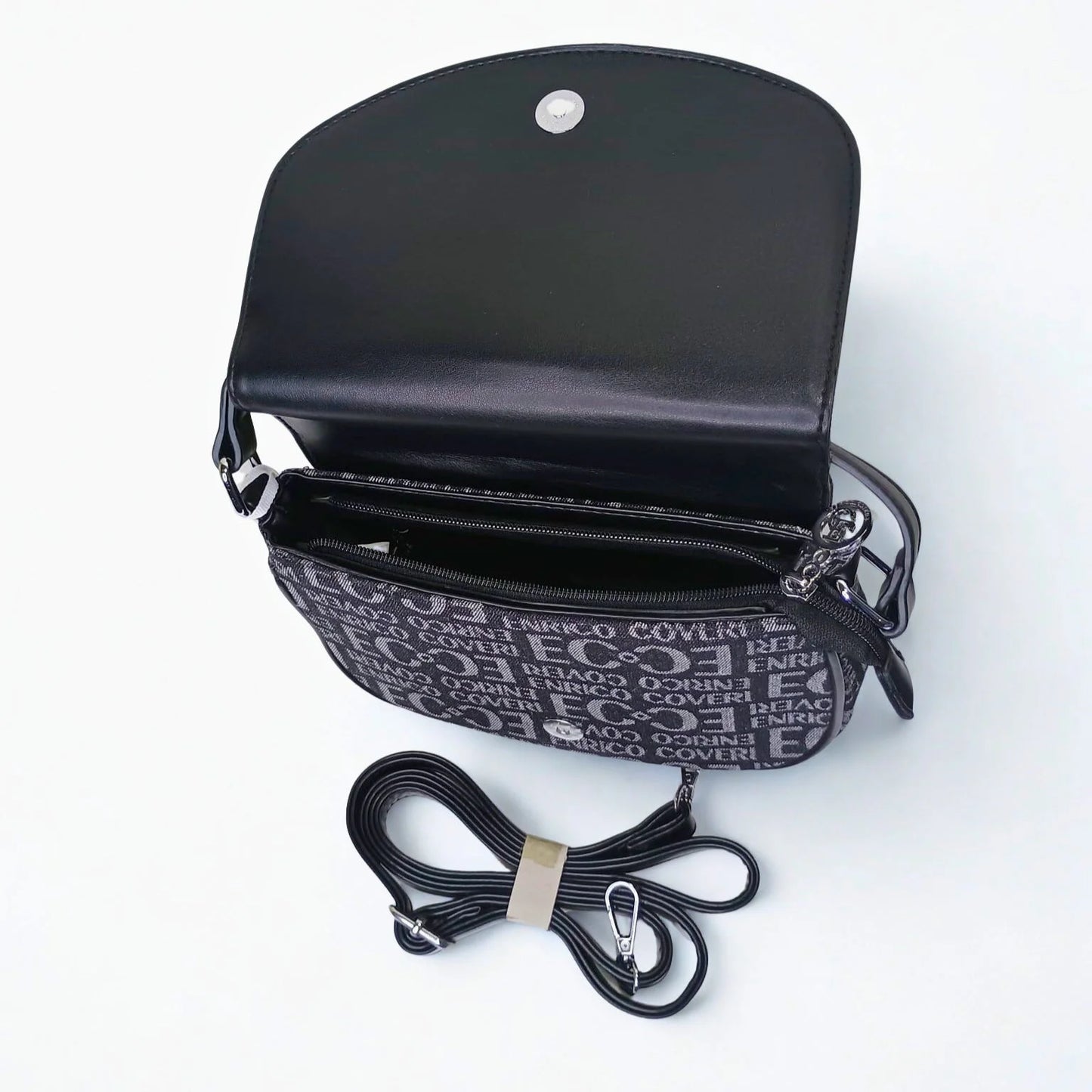 Black handbag with a detachable strap on a white background