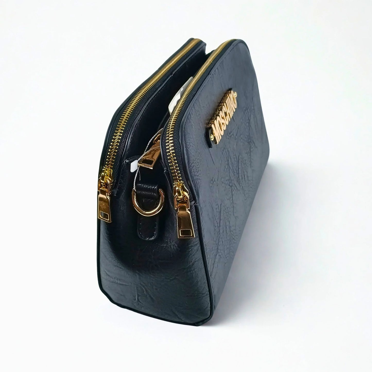 Black handbag with gold zipper and handle on a white background