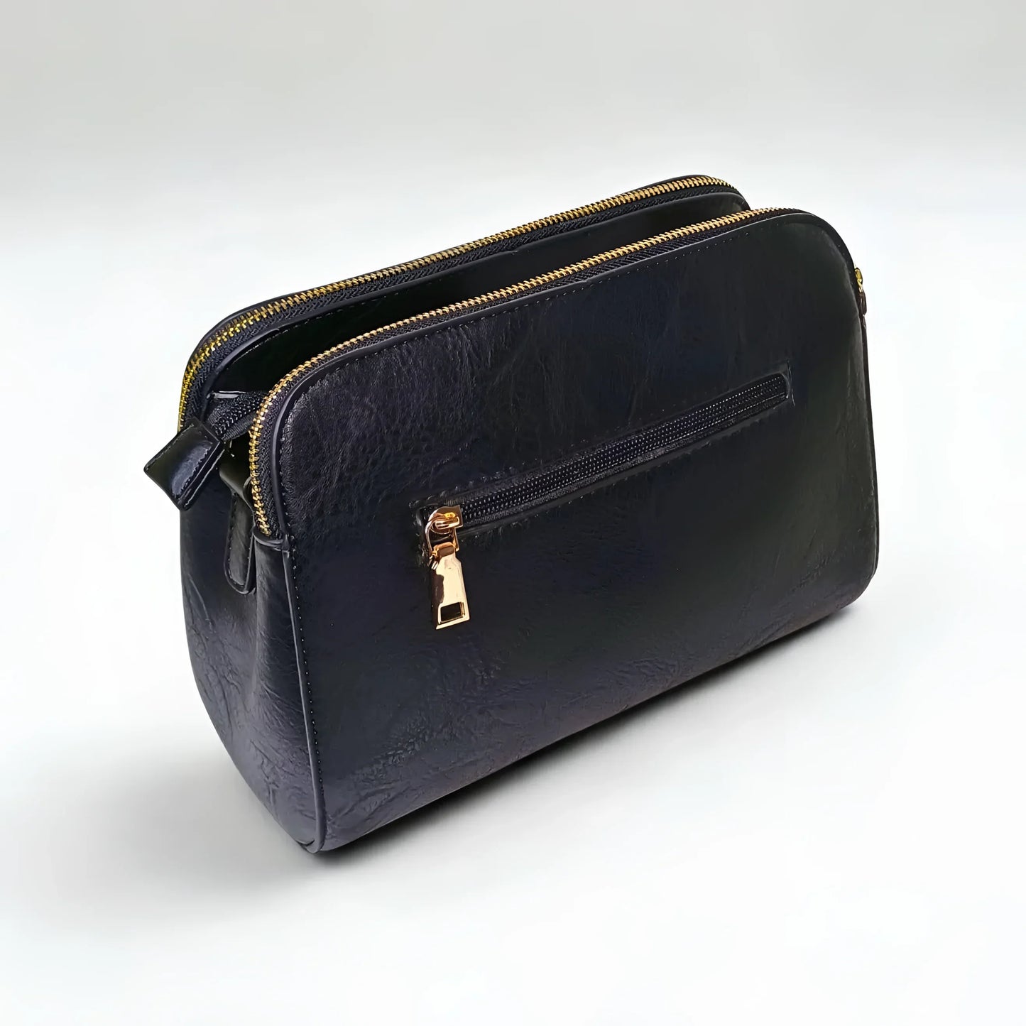 Black leather handbag with gold zipper on a white background