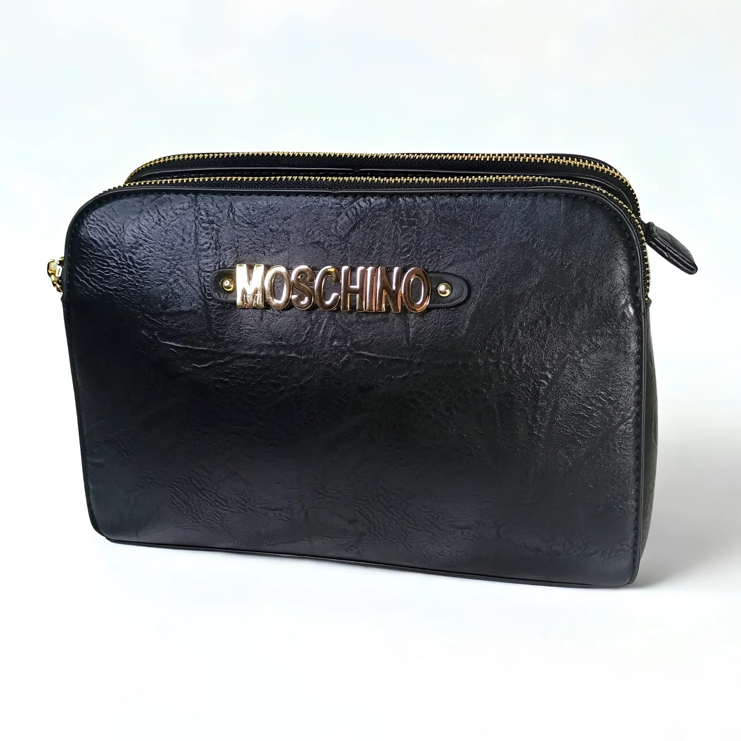 Black leather pouch with gold zipper and Moschino logo on a white background