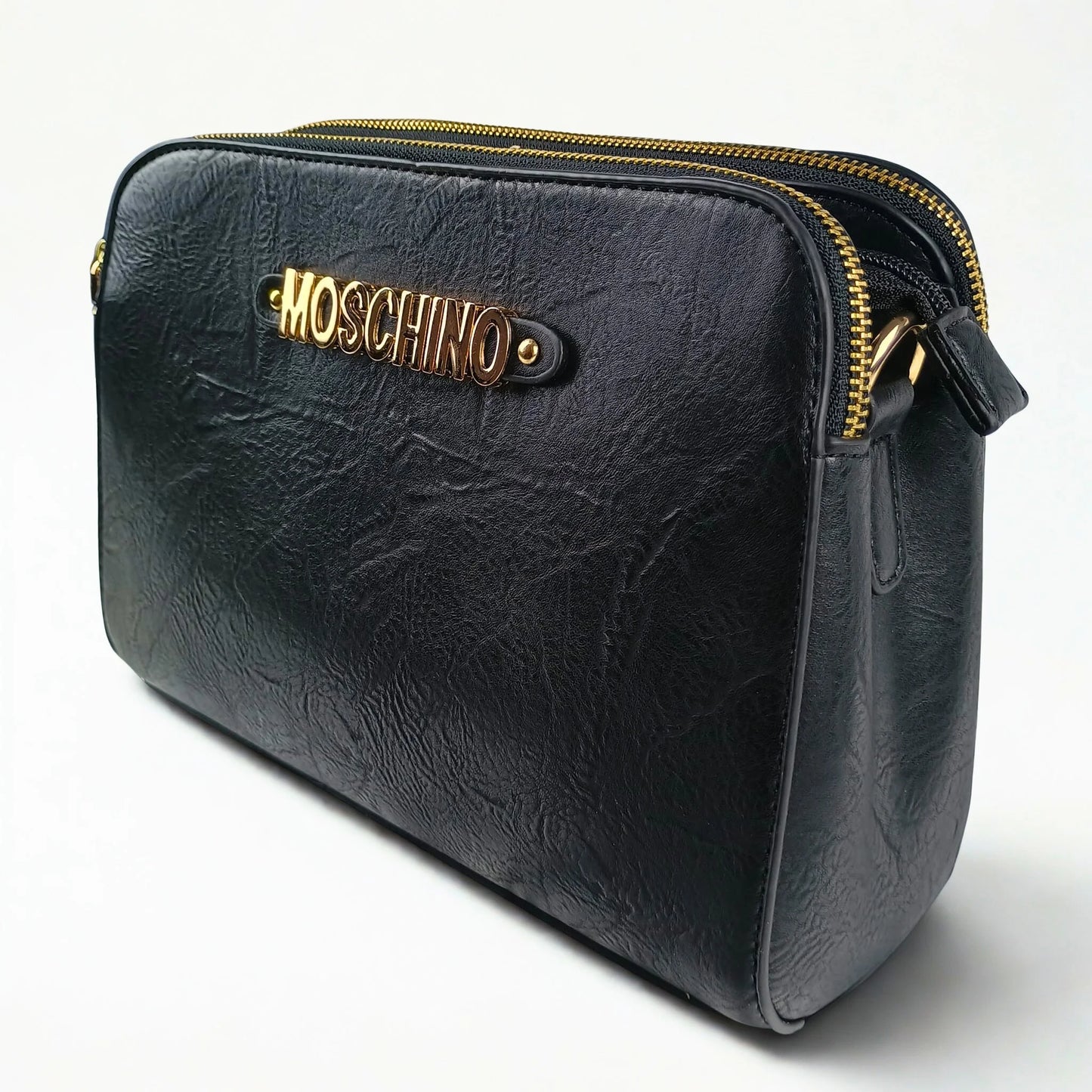 Black leather handbag with gold zipper and Moschino logo on a white background