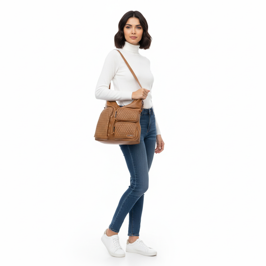 Woman holding a brown handbag against a white background