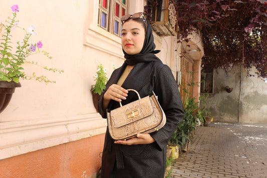 Woman in black hijab holding a stylish handbag