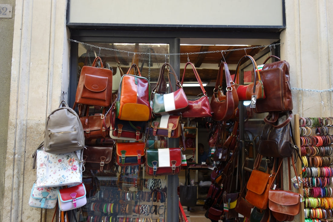 Leather bags and accessories displayed outside a shop.