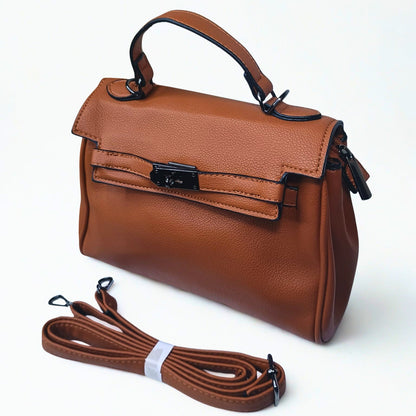 Brown leather handbag with a detachable strap on a white background