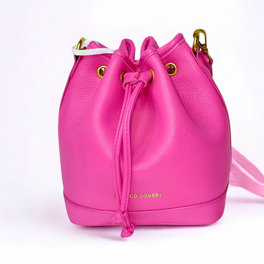 Pink leather bucket bag with gold hardware on a white background