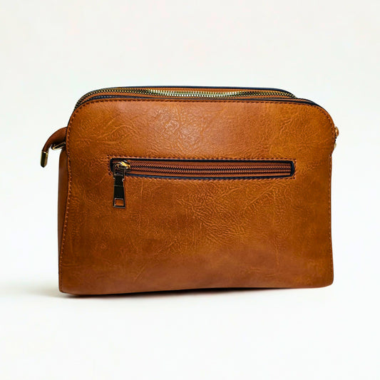 Brown leather bag with zippers on a white background