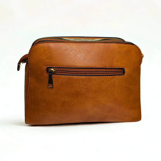 Brown leather bag with zippers on a white background