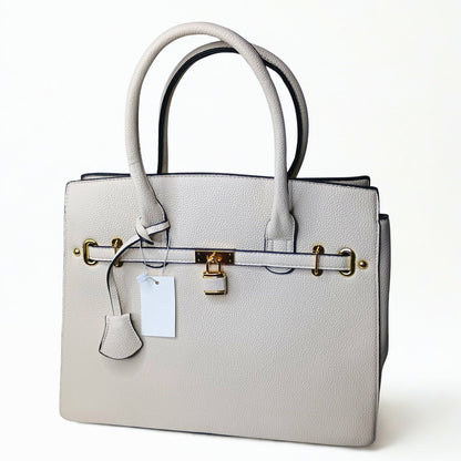 Gray handbag with gold hardware on a white background