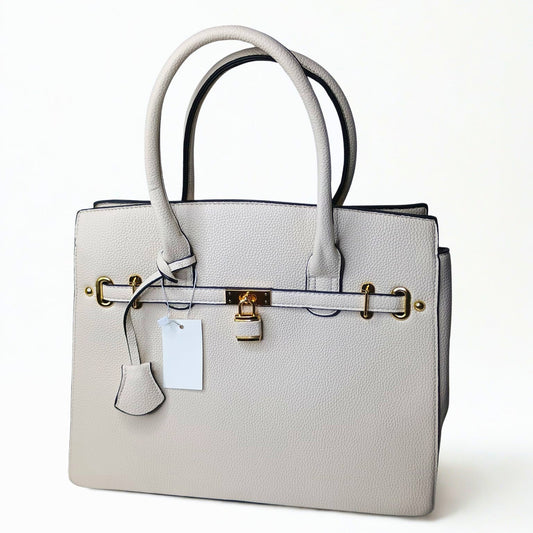Gray handbag with gold hardware on a white background