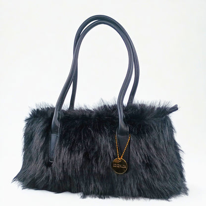 Black fur handbag with a gold pendant on a white background