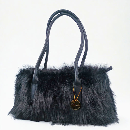 Black fur handbag with a gold pendant on a white background