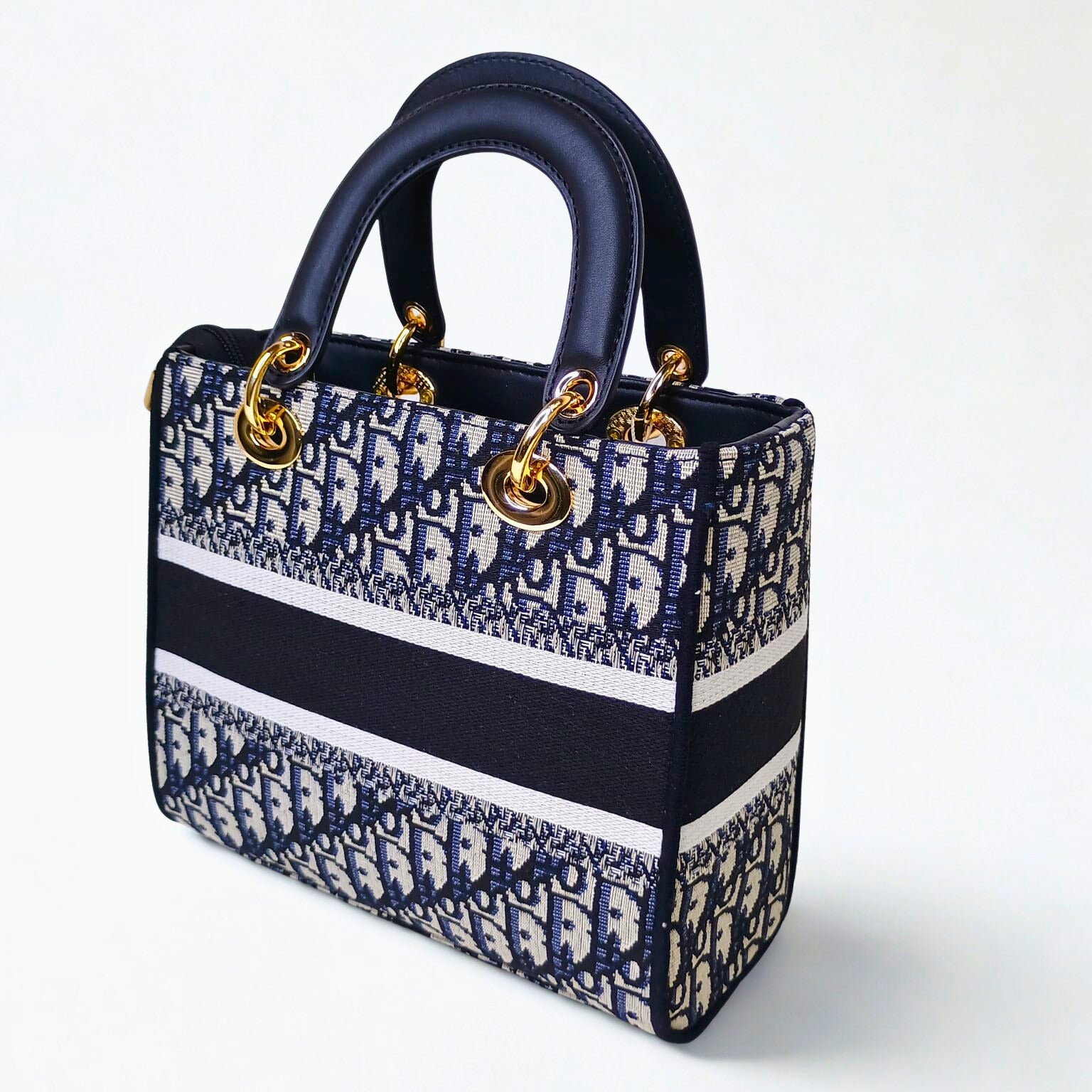 Designer handbag with blue and white pattern on a white background