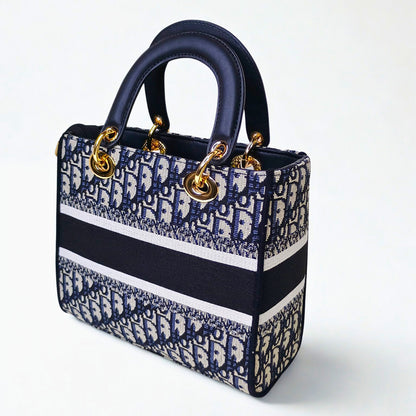Designer handbag with blue and white pattern on a white background