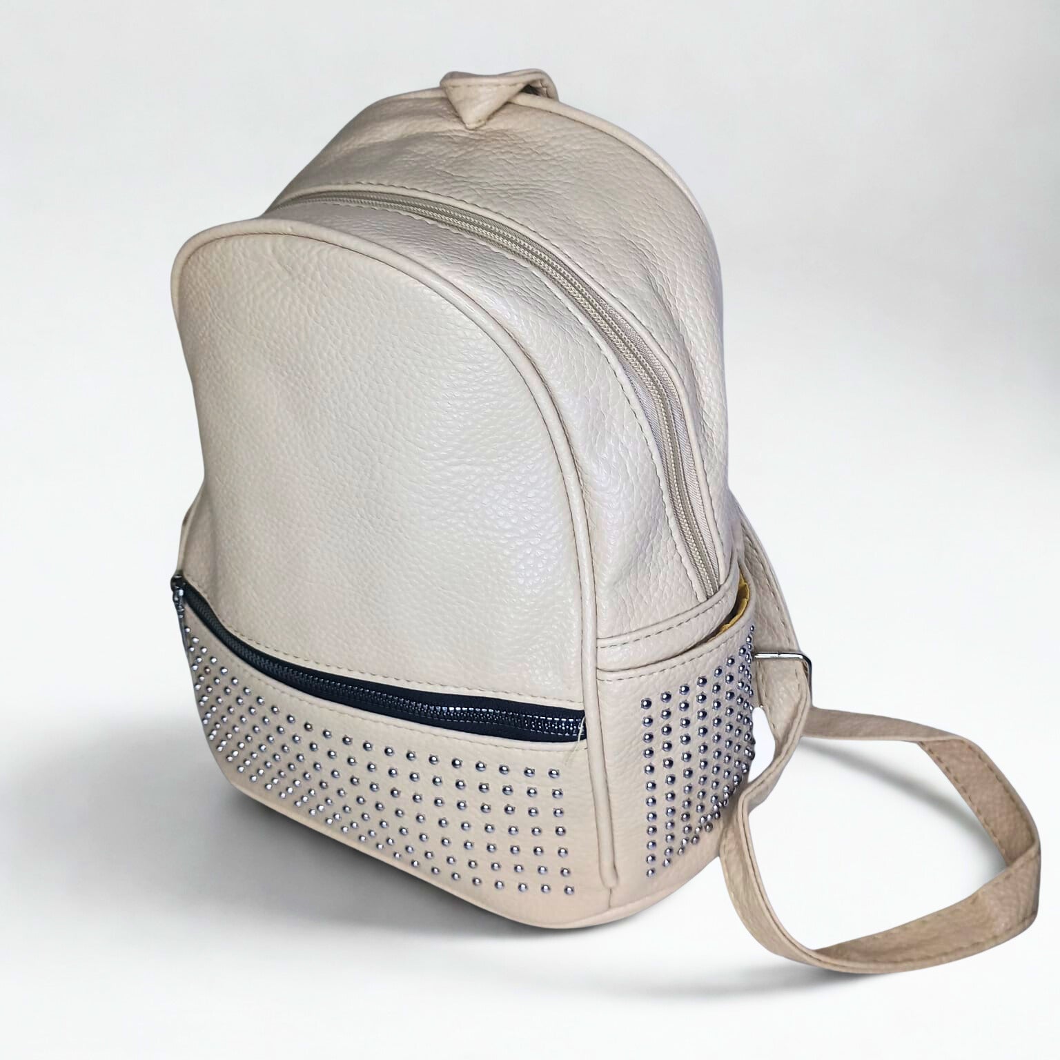 Beige backpack with studded detail on a white background