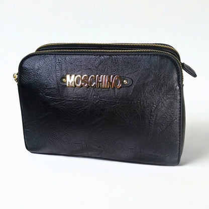 Black leather pouch with gold zipper and Moschino logo on a white background