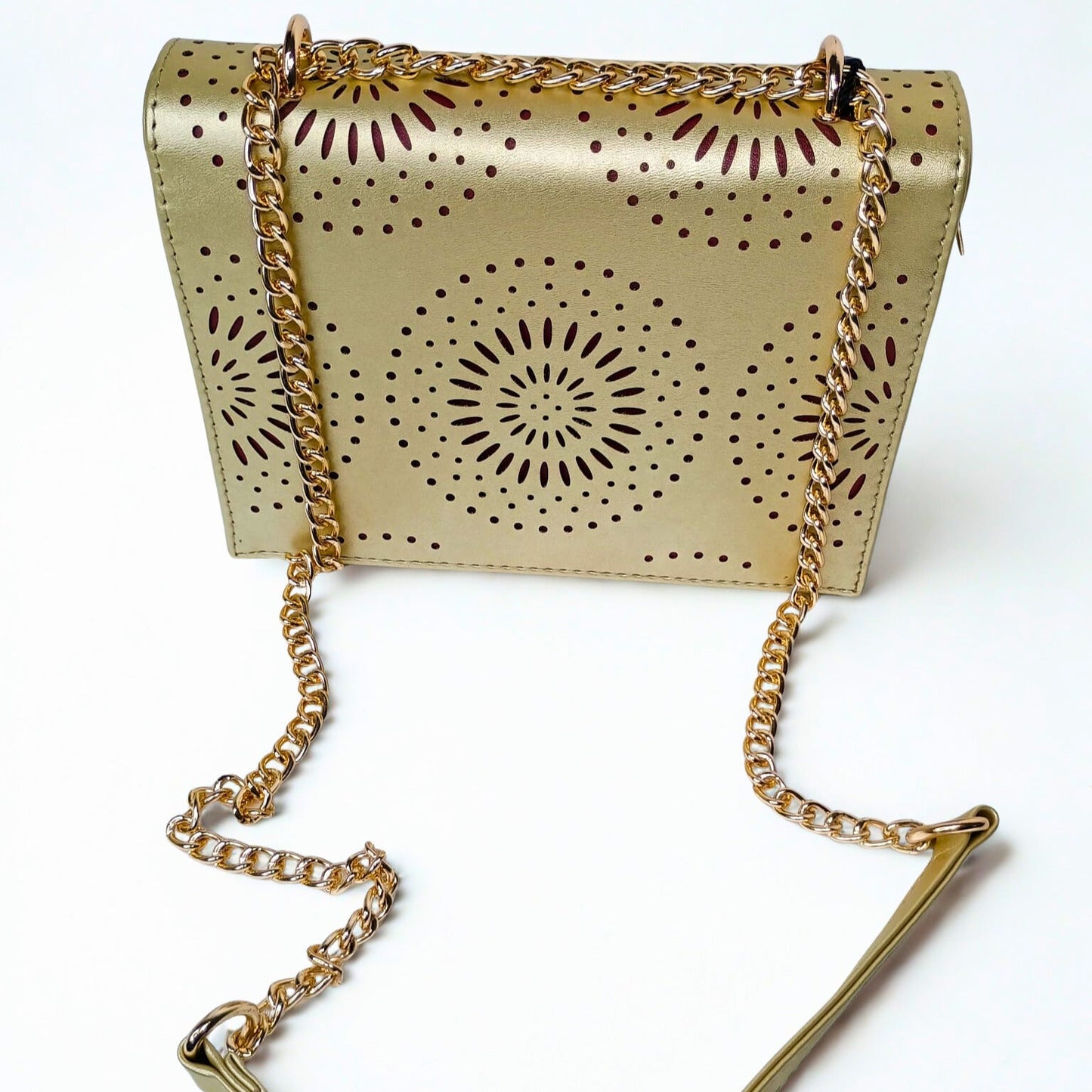 Gold handbag with chain strap on a white background