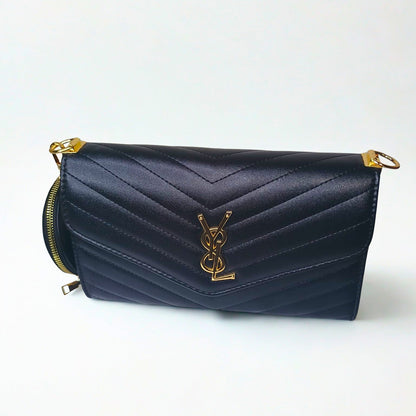 Navy blue handbag with gold accents on a white background