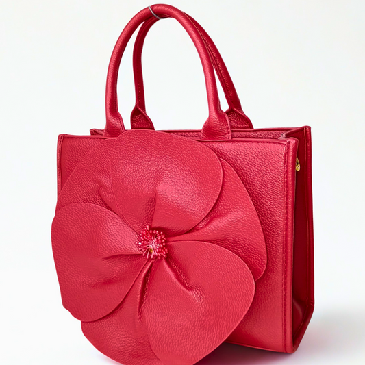 Red handbag with a large floral design on a white background