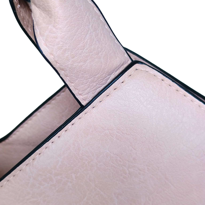 Close-up of a beige leather handbag handle on a white background