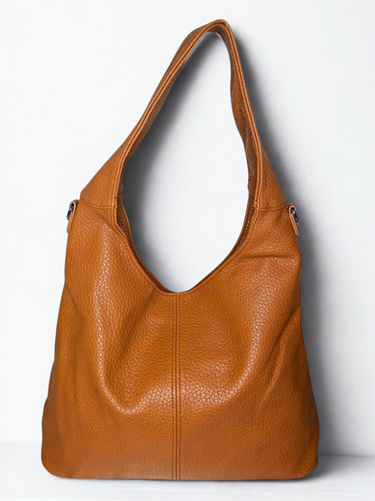 Brown leather handbag on a white background