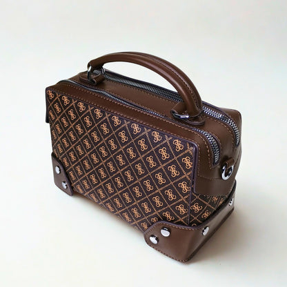Brown handbag with patterned front section on a white background