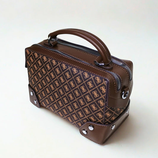 Brown handbag with patterned front section on a white background